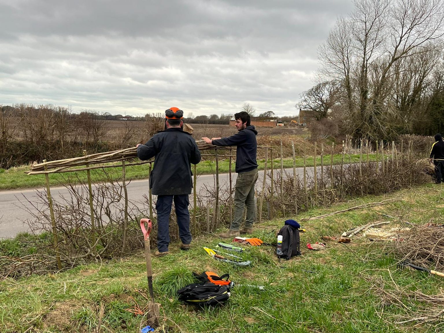 men making fence